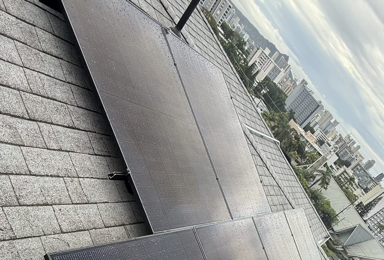 Rooftop solar array overlooking the Honolulu skyline