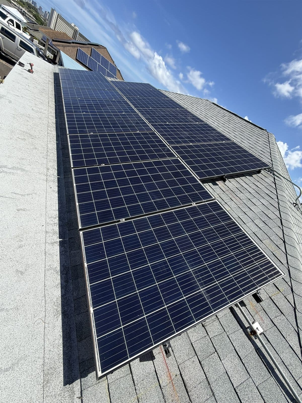 Older-generation solar panels on a roof, ready for removal and reinstall